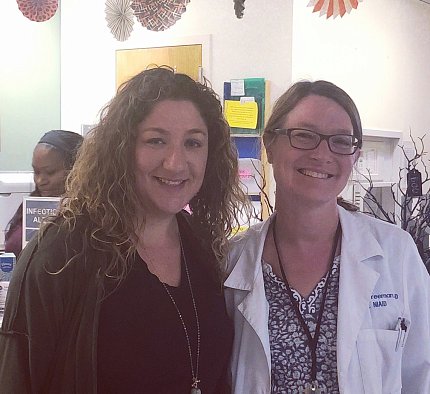 Harper Spero and Dr. Freeman pose together in a Clinical Center hallway.