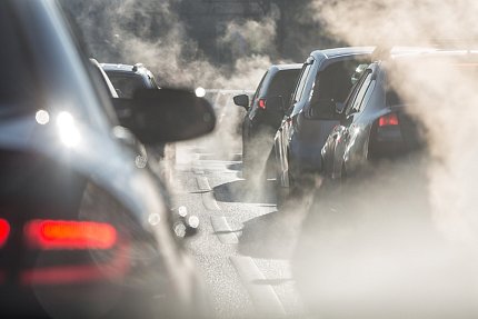 Cars on the road with smoky plumes from car exhaust