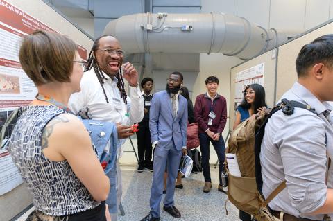 Platt speaks to his colleagues during a poster session