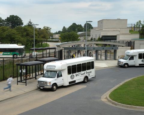 Person runs toward Rockledge shuttle van outside Medical Center metro station and Gateway Center
