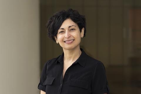 Headshot of Vallabh, who is wearing black and pictured against a dark background.