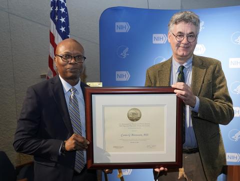 Bönnemann (right) and Clinical Center CEO Pius Aiyelawo hold lecture award.