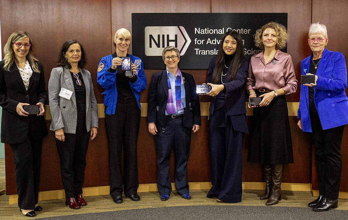 Rubins and some of her co-panelists, holding small plaques.