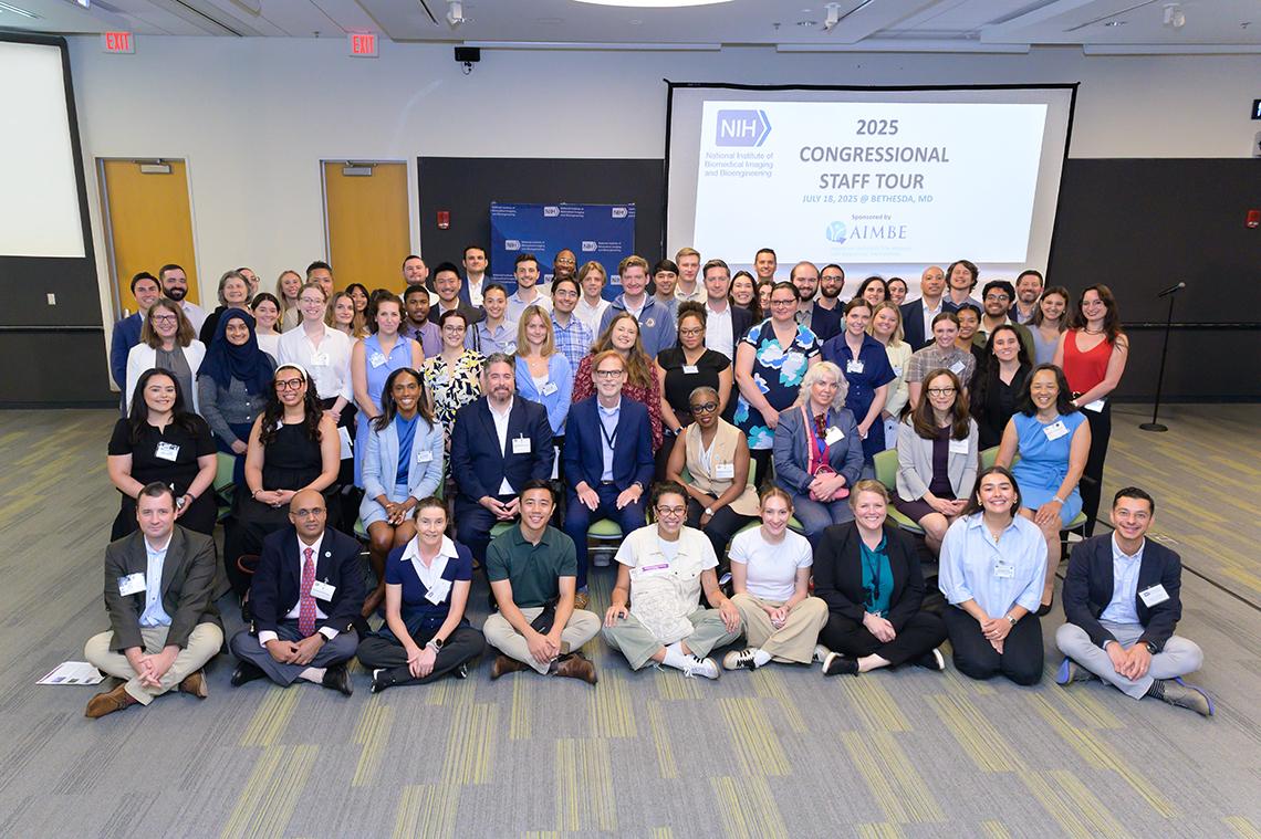 A large group of congressional staffers and NIBIB leadership pose together.
