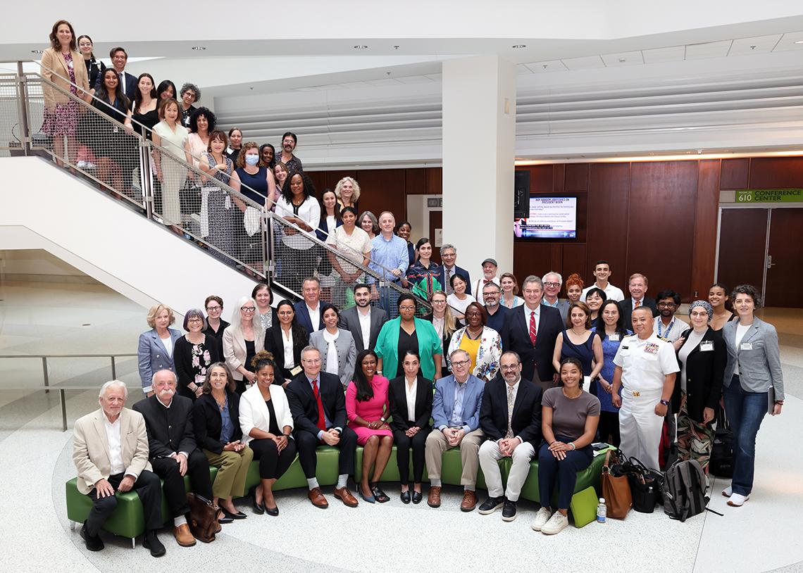 A large group winds their way up the staircase in the Porter Neuroscience Center.