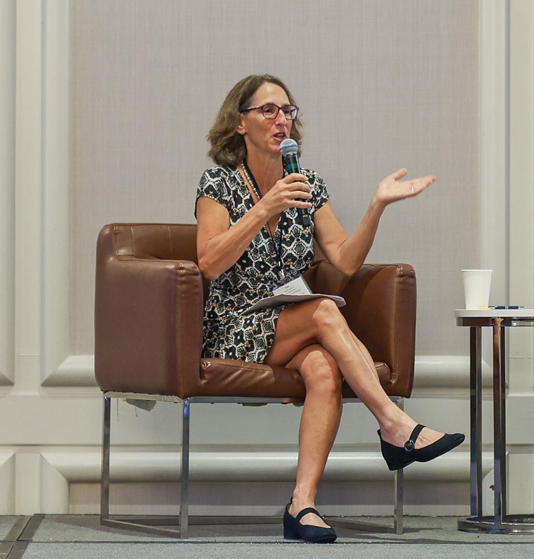 Dr. Jane Simoni talks into mic while seated.