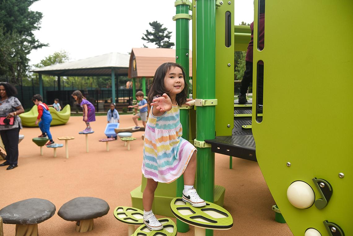 A child climbs up playground equipment