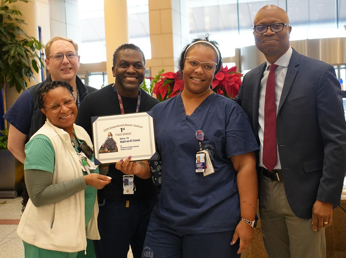 Winning team from the CC poses with Aiyelawo.