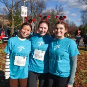 Three participants wear the same shirt at the relay