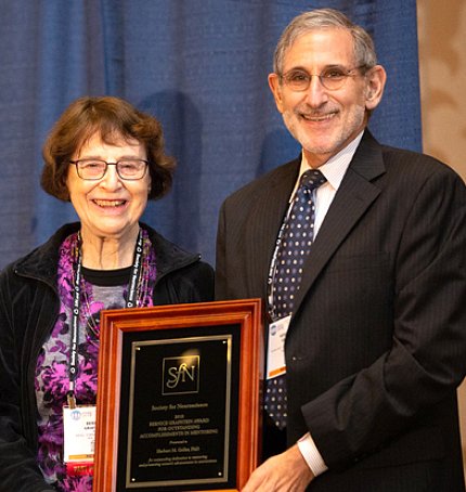Dr. Herbert Geller and Bernice Grafstein Dr. Geller receives a plaque from Dr. Grafstein