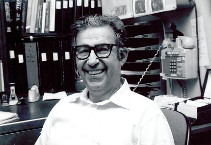 Dr. Saul Rosen Dr. Rosen smiles in his office