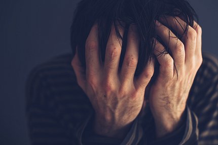 low-dose ketamine infusion A man holding his head