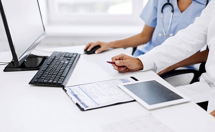 Doctor and nurse A doctor and a nurse look at a computer screen