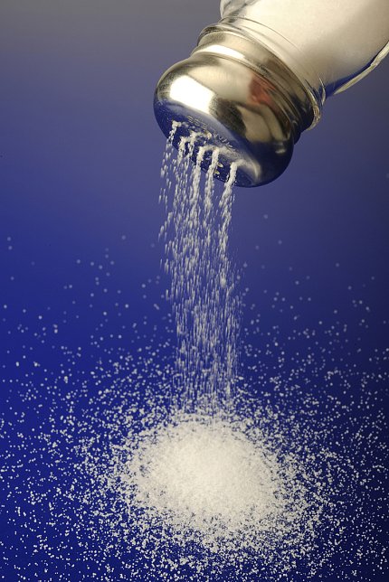 High levels of salt Table salt pours out of a salt shaker